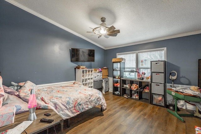 bedroom with ceiling fan, crown molding, wood-type flooring, and a textured ceiling