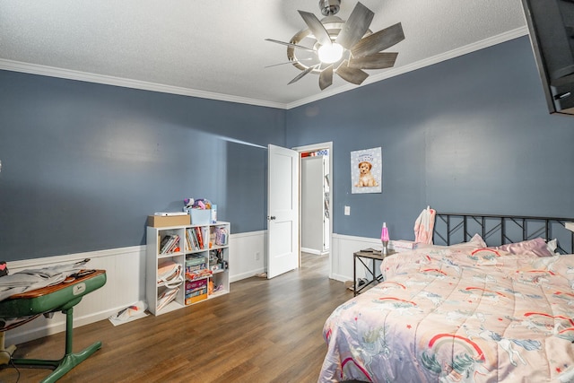 bedroom with ceiling fan, crown molding, dark wood-type flooring, and a textured ceiling