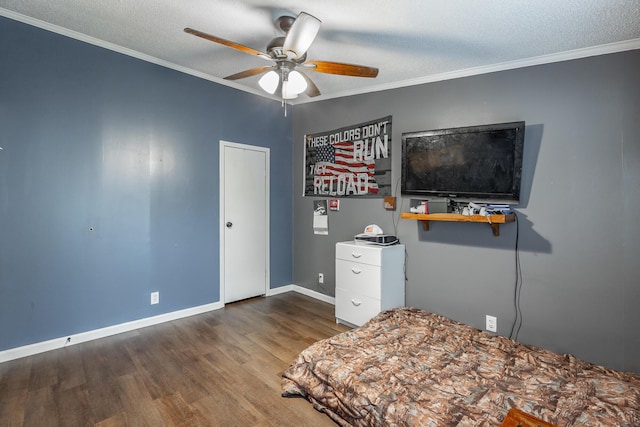 bedroom with ceiling fan, dark hardwood / wood-style flooring, ornamental molding, and a textured ceiling