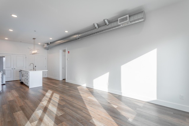 unfurnished living room with sink and dark hardwood / wood-style floors