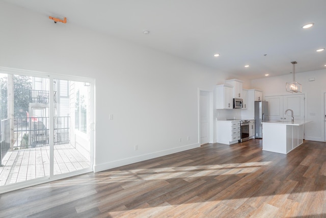 unfurnished living room with sink and dark wood-type flooring