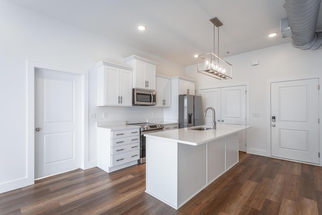 kitchen with white cabinets, a kitchen island with sink, dark wood-type flooring, and appliances with stainless steel finishes