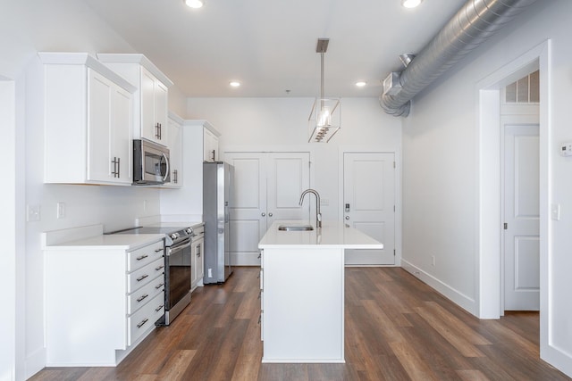 kitchen featuring a kitchen island with sink, white cabinets, stainless steel appliances, and dark hardwood / wood-style floors