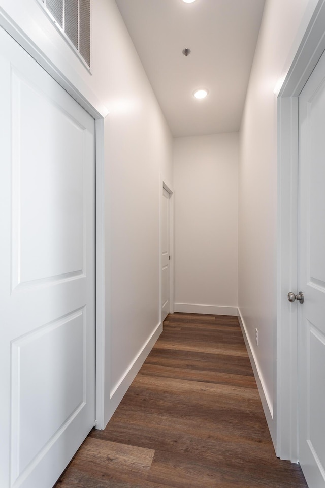 hallway with dark hardwood / wood-style flooring