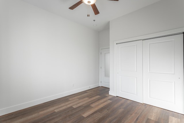 unfurnished bedroom featuring a closet, ceiling fan, and dark wood-type flooring