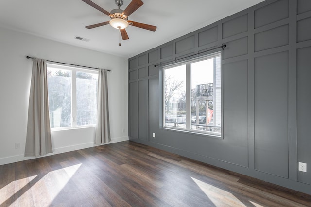 unfurnished room with dark hardwood / wood-style floors and ceiling fan