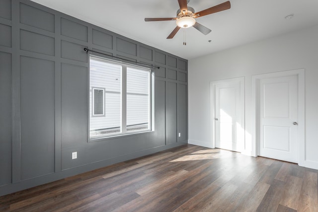 unfurnished bedroom with ceiling fan and dark hardwood / wood-style floors