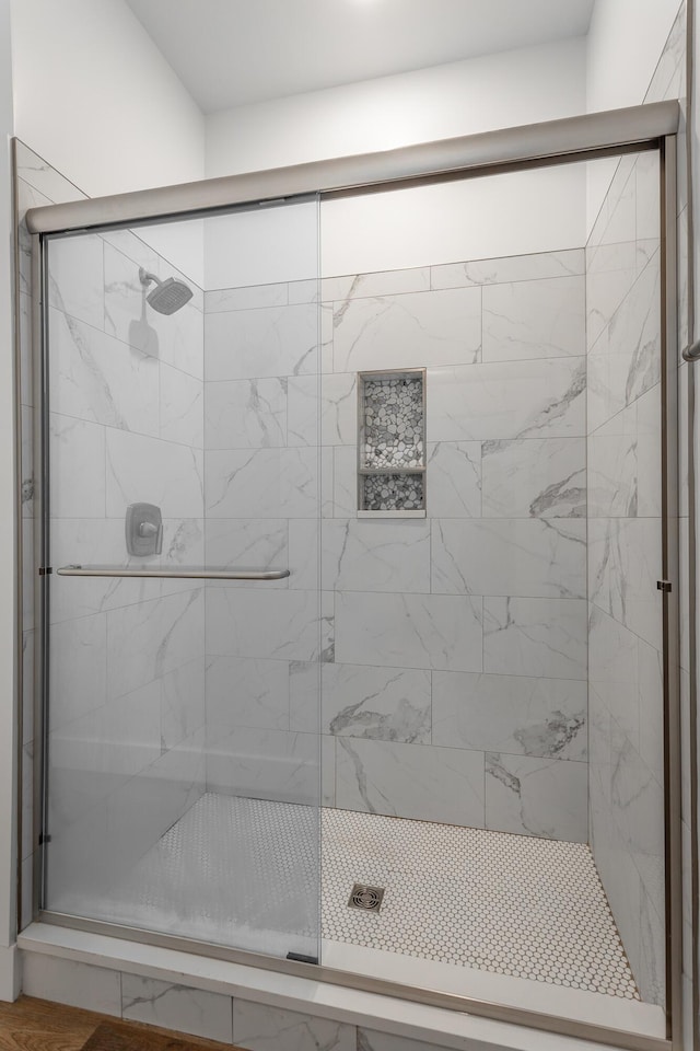 bathroom with a shower with door