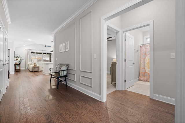 hall with hardwood / wood-style floors and crown molding