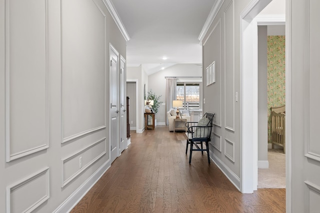 hallway with dark hardwood / wood-style flooring and ornamental molding