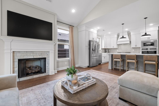 living room featuring dark hardwood / wood-style flooring and vaulted ceiling