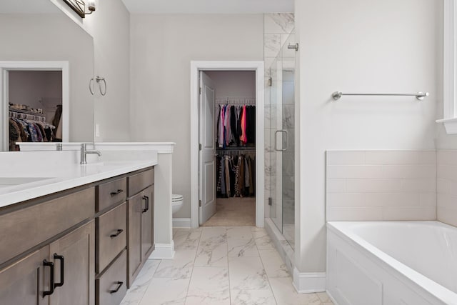 full bathroom featuring toilet, vanity, and separate shower and tub