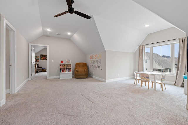 rec room with ceiling fan, light colored carpet, and lofted ceiling