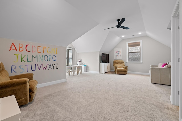 sitting room featuring light carpet, vaulted ceiling, and ceiling fan