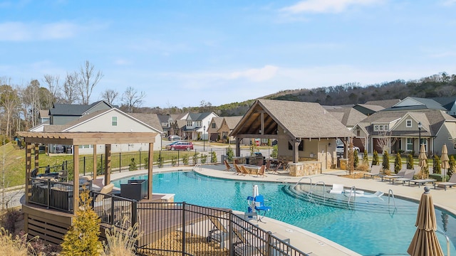 view of swimming pool with a bar and a patio