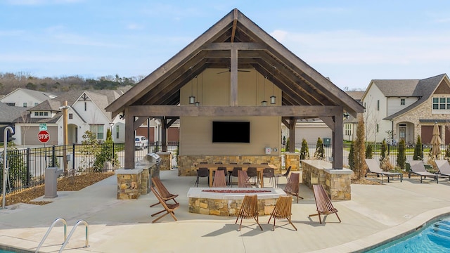 exterior space with a gazebo, a fenced in pool, and an outdoor fire pit