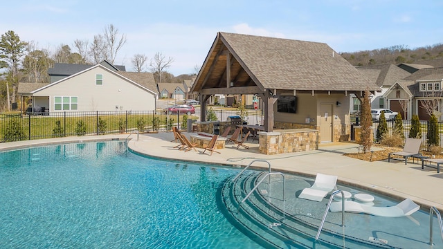 view of swimming pool with a patio area and an outbuilding