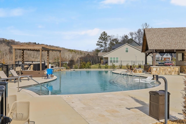 view of pool with exterior bar, a gazebo, and a patio