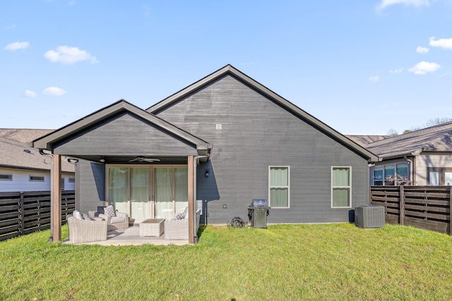 back of property featuring ceiling fan, a yard, cooling unit, and an outdoor living space