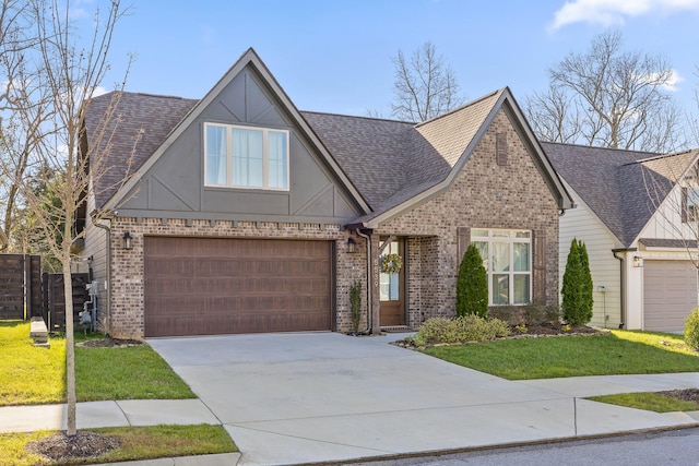 view of front of house featuring a front yard and a garage