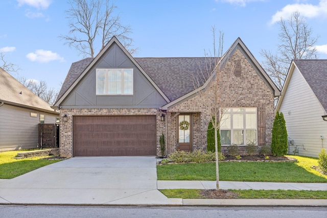 view of front of property featuring a garage and a front lawn