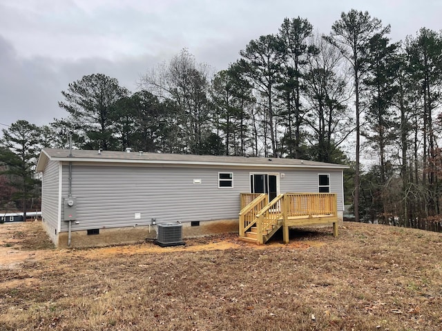 back of property with cooling unit and a deck