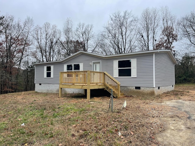 back of house with a deck