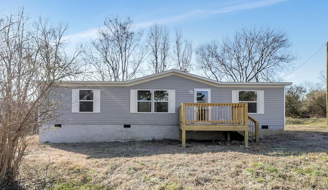 rear view of house featuring a wooden deck