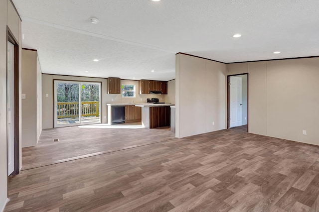 unfurnished living room featuring ornamental molding, a textured ceiling, and light wood-type flooring