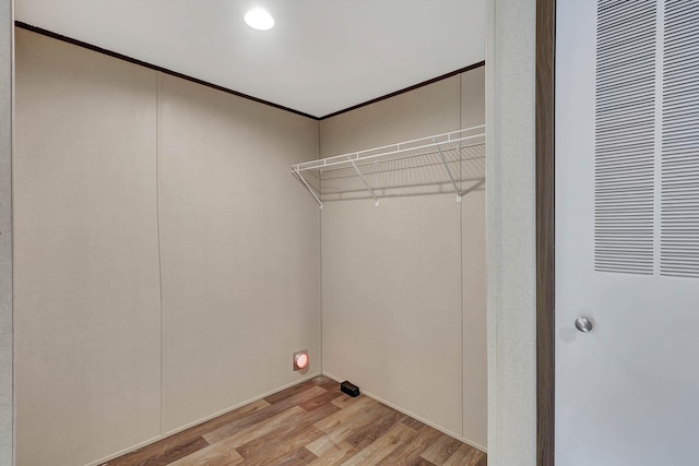 washroom with crown molding and light hardwood / wood-style flooring