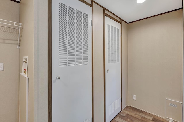 interior space with ornamental molding and light wood-type flooring