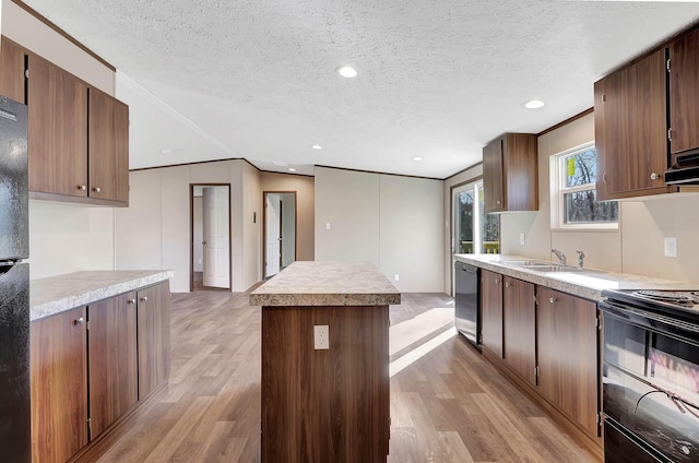 kitchen with a kitchen island, sink, stainless steel dishwasher, electric range, and light hardwood / wood-style floors