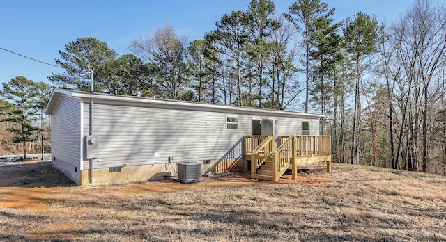 back of property with central AC and a deck