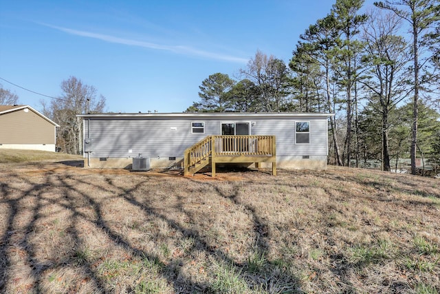 view of front of home with a wooden deck and central AC