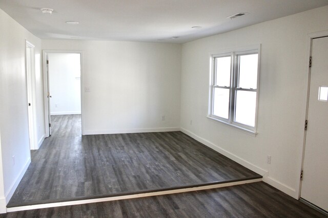 unfurnished room with dark hardwood / wood-style floors