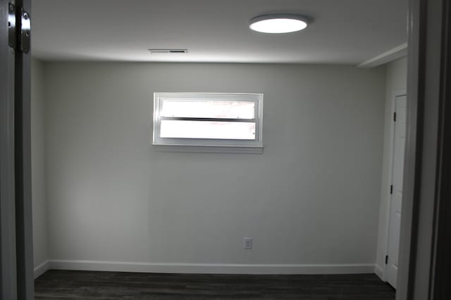 spare room featuring dark wood-type flooring