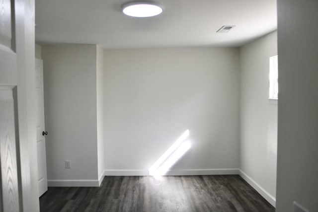 empty room featuring dark wood-type flooring