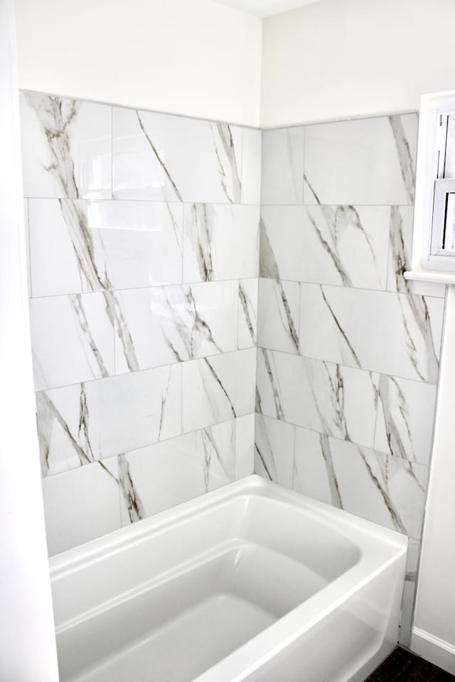 bathroom with a tub to relax in