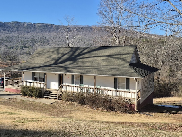 view of front facade featuring a porch and a mountain view