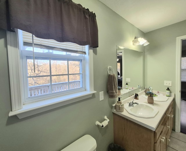 bathroom featuring toilet, tile patterned flooring, and vanity