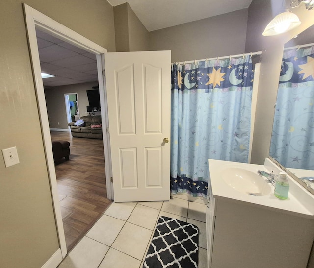 bathroom with a shower with shower curtain, tile patterned flooring, and vanity