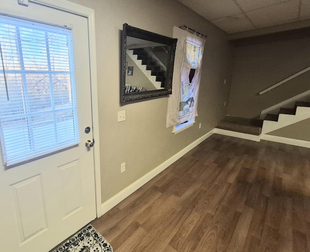 entrance foyer with dark wood-type flooring and a paneled ceiling