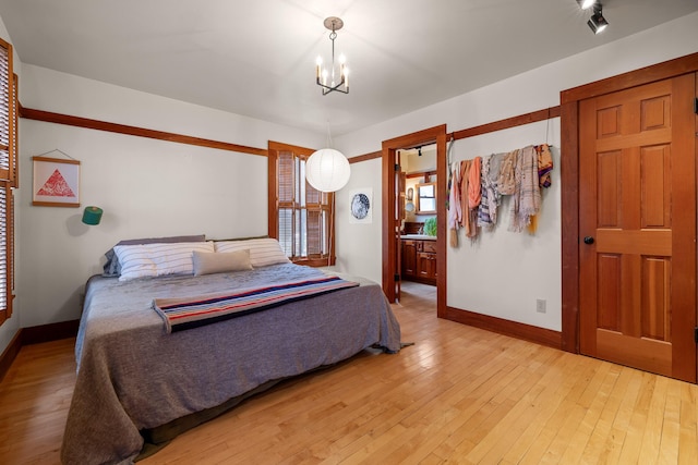 bedroom featuring light hardwood / wood-style flooring and a notable chandelier