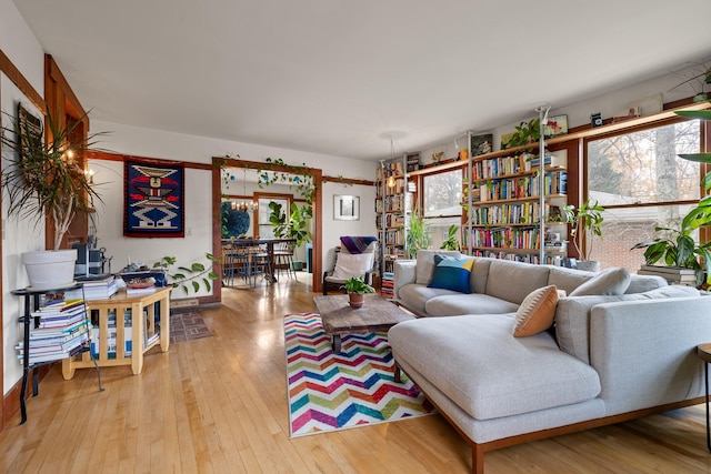 living room featuring light hardwood / wood-style floors and an inviting chandelier