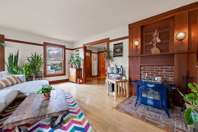 living room featuring light hardwood / wood-style floors and a wood stove