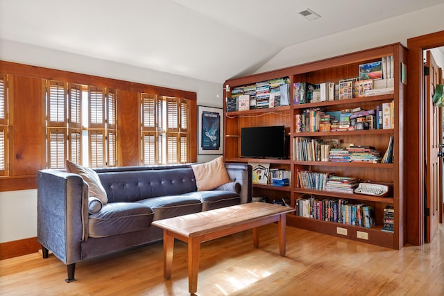 sitting room with light hardwood / wood-style flooring and lofted ceiling