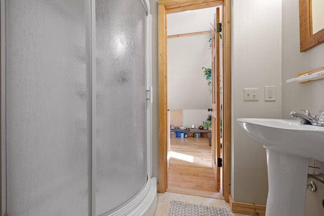 bathroom with tile patterned flooring and walk in shower