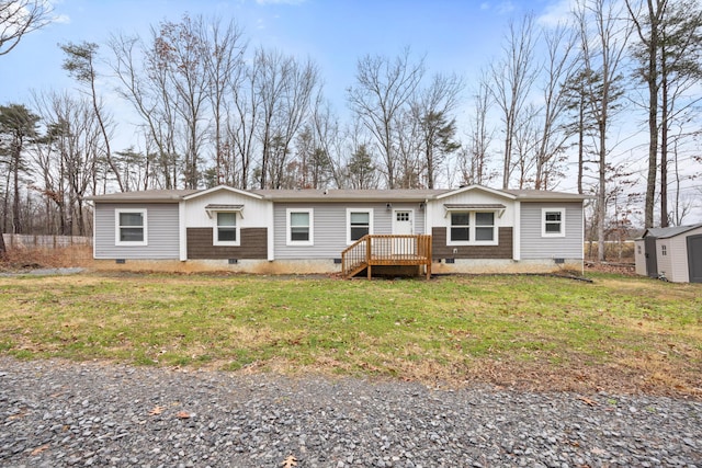 view of front of property with a deck and a front lawn