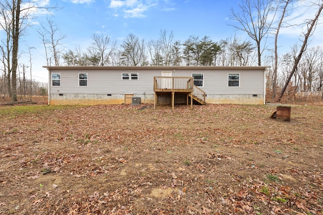 rear view of property with central AC unit and a wooden deck