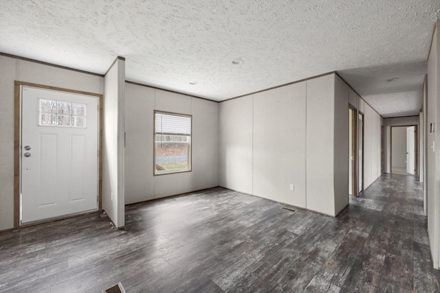 entryway with dark hardwood / wood-style floors and a textured ceiling